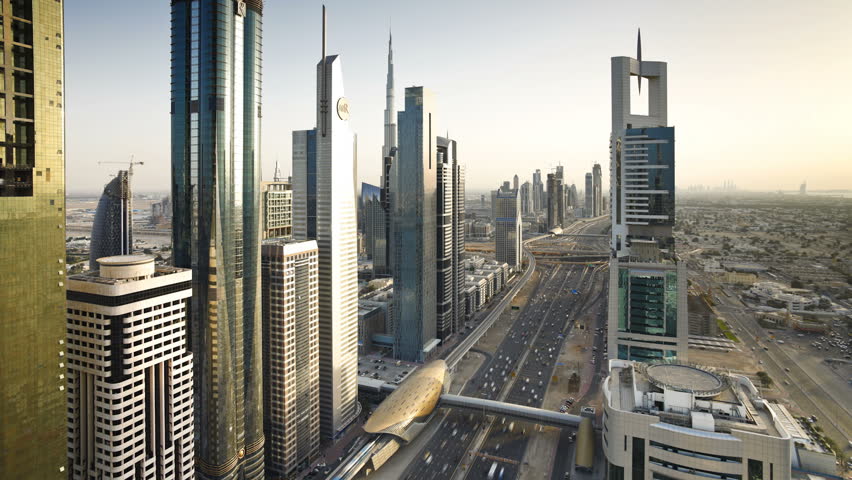 DUBAI, UNITED ARAB EMIRATES - CIRCA MAY 2011: showing the new MTR track and station system and the Burj Khalifa at early dusk