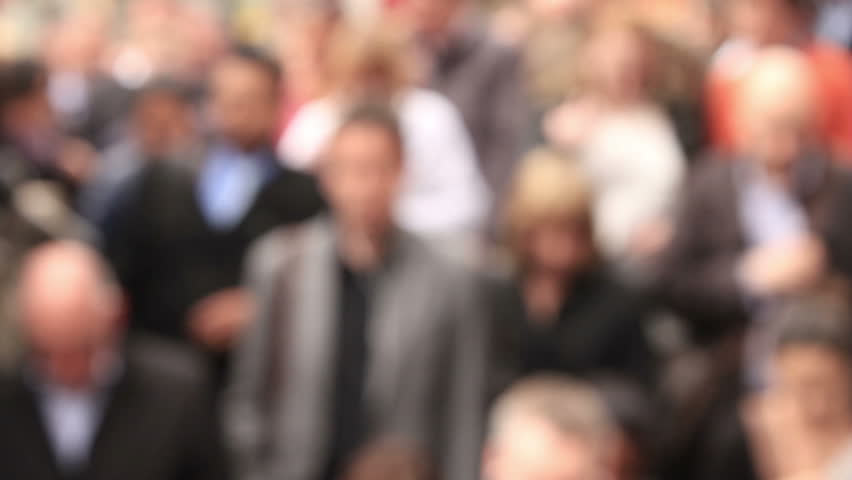 Anonymous, blurred shoppers and commuters enter Oxford Circus tube station, London