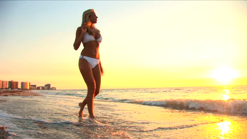 Beautiful blonde girl enjoys the beach lifestyle