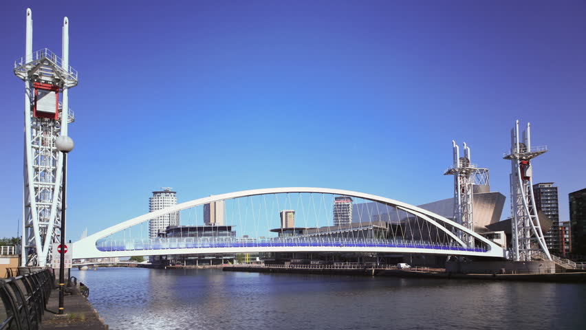 MANCHESTER, LANCASHIRE/ENGLAND - JUNE 6: Millennium Bridge opens for shipping to pass under on June 6, 2011 in Salford Quays. It is a vertical lift bridge, completed in 2000.