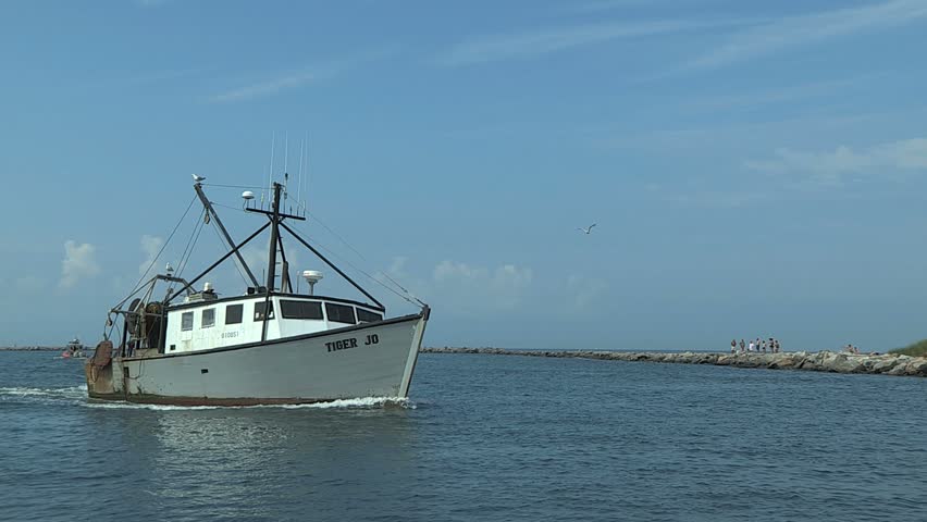 POINT JUDITH, RHODE ISLAND - CIRCA JULY 2010: Nice older white fishing boat coming into port