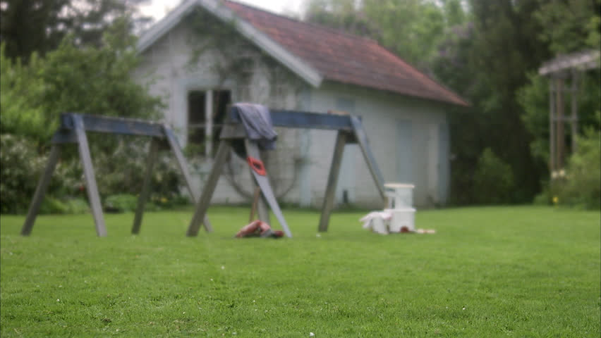 A woman doing carpentry in a garden