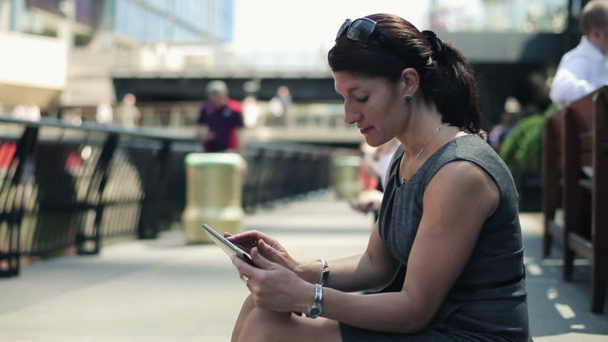 Young businesswoman with tablet computer in the city
