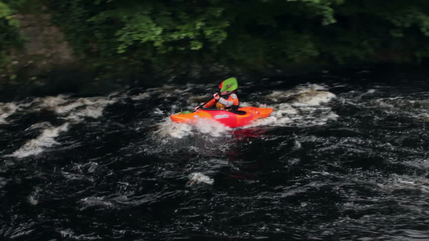BALA, GWYNEDD/WALES - JULY 21: Unidentified woman in kayak paddles down river on July 21, 2012 in Bala. A dam periodically releases water down the River Tryweryn which creates the rapids.
