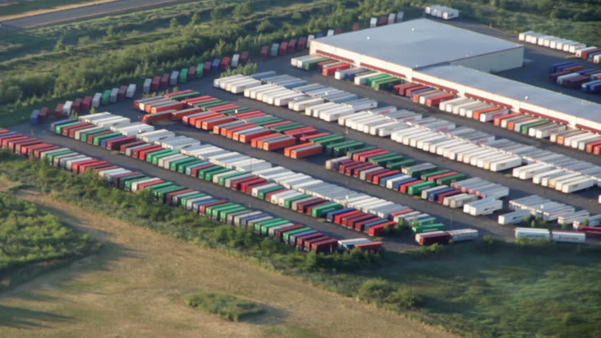 Aerial perspective of cargo transport trucks at large freight hub