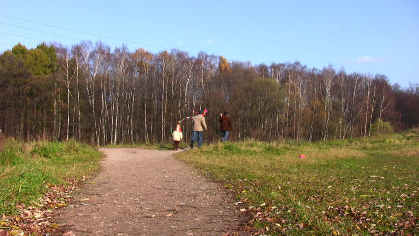 son, father and grandfather running with kite 