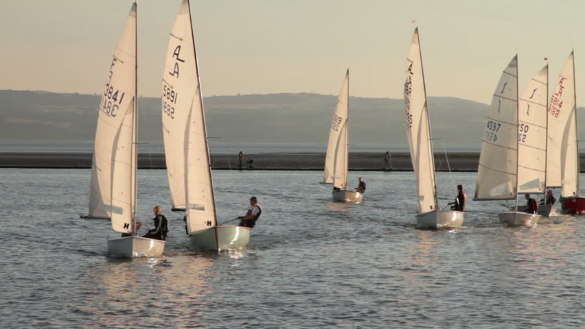 WEST KIRBY, WIRRAL/ENGLAND - AUGUST 9: Sailing dinghies race towards camera on August 9, 2012 in West Kirby. The Marine Lake is a man made coastal lake fed by the sea at high tide.  