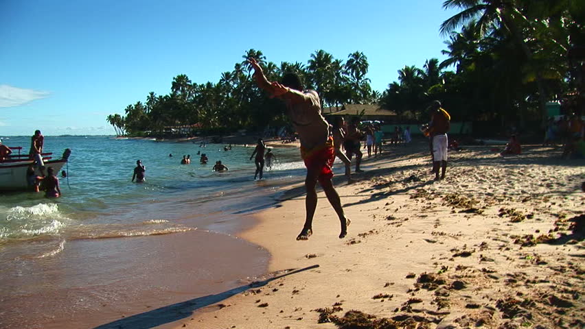 SALVADOR, BRAZIL - April 2008: Beach artist doing gymnastics in Salvador, Bahia, Brazil