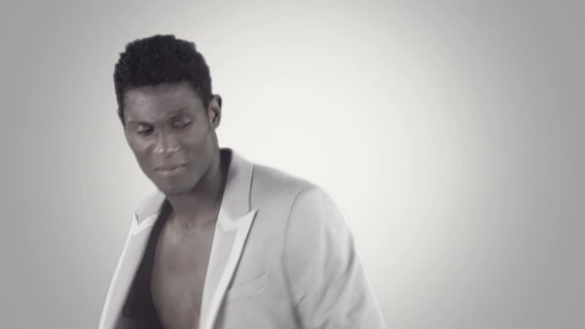 young african guy waving and dancing with a cool attitude with an elegant suite
