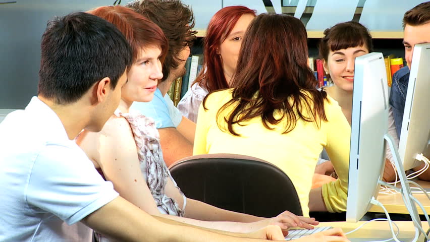 Male and female team of college classmates learning with brunette teacher internet new education programs