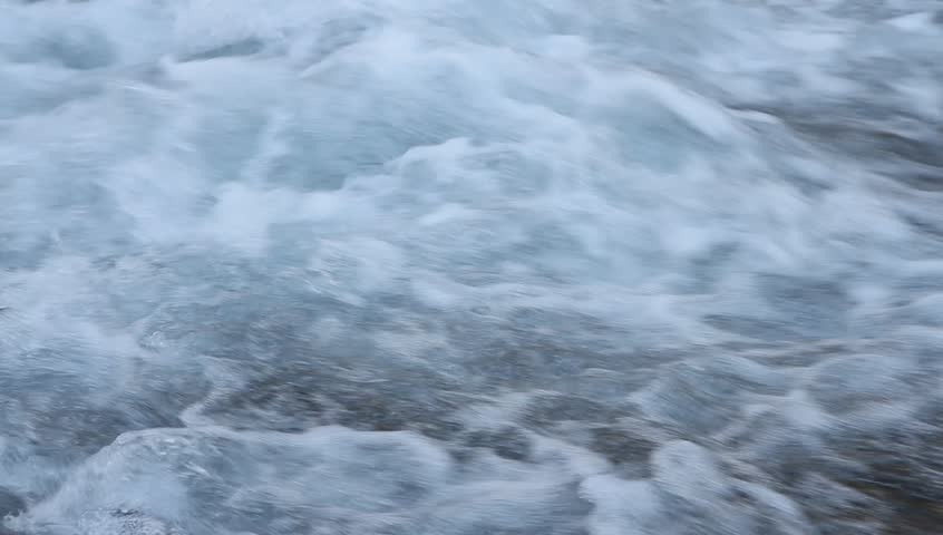 Cold mountain stream of water sated with air vials