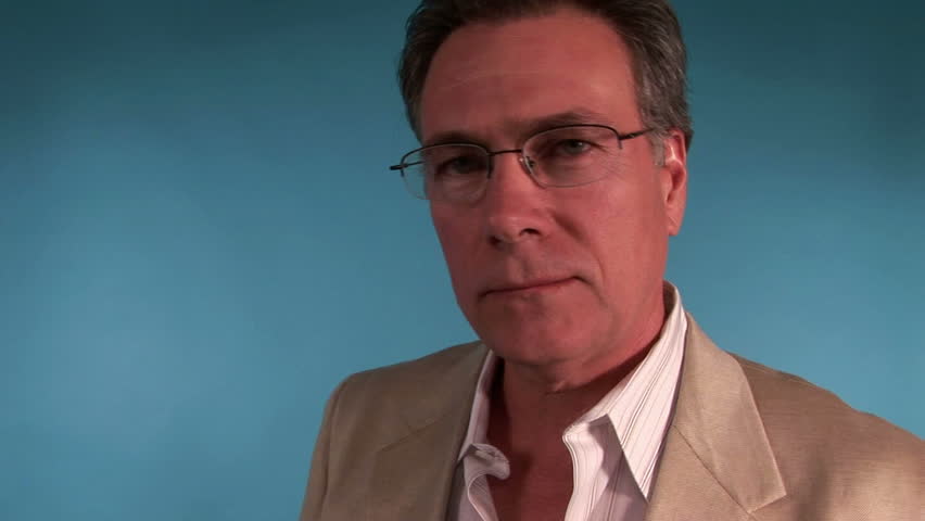 An angry man yelling and pointing into the camera. 