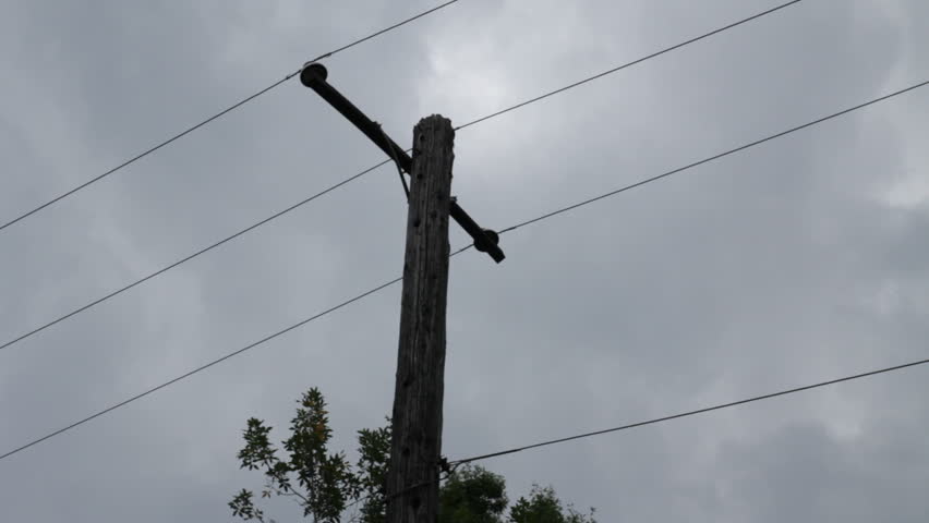 Telephone pole silowette slow clouds