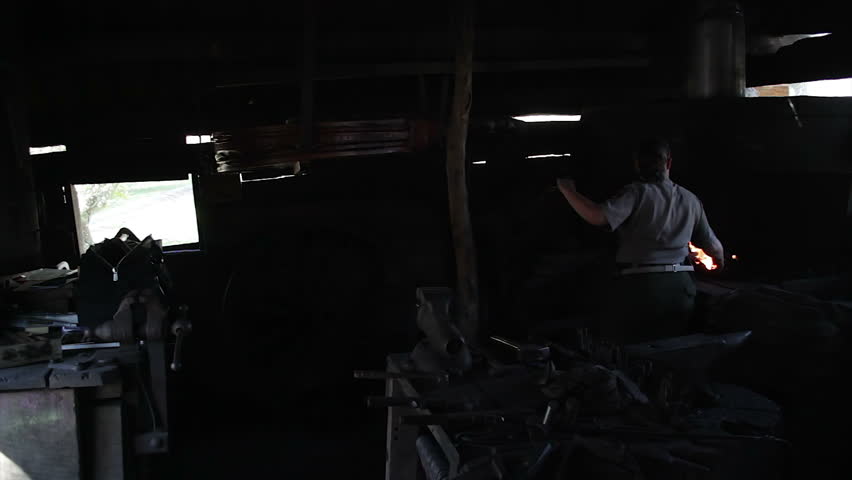 ROANOKE, USA - OCTOBER 27: A local park ranger demonstrates old blacksmithing techniques at a mill in the Blue Ridge Mountains, Virginia, USA.