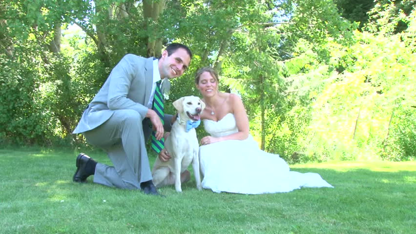 Model released bride and groom with their dog, posing for portraits on their wedding day.