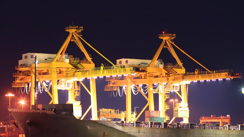 Container Cargo freight ship with working crane bridge in shipyard at dusk for Logistic Import Export background