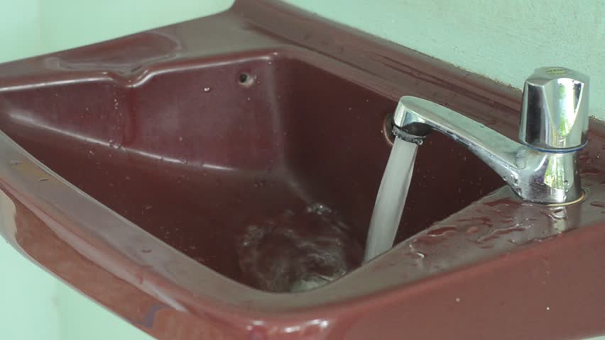 Washing hands in a public restroom