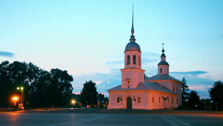 Couple walk away by Kremlin square in morning with Alexander Nevsky Church in Vologda, Russia