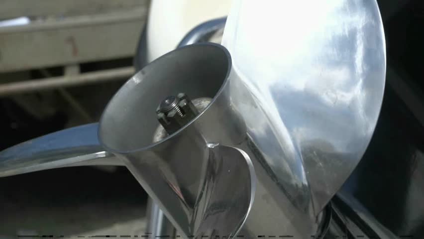 New Zealand. October 2012. Marine mechanic tightening the propeller nut on a outboard motor before inserting the cotter pin