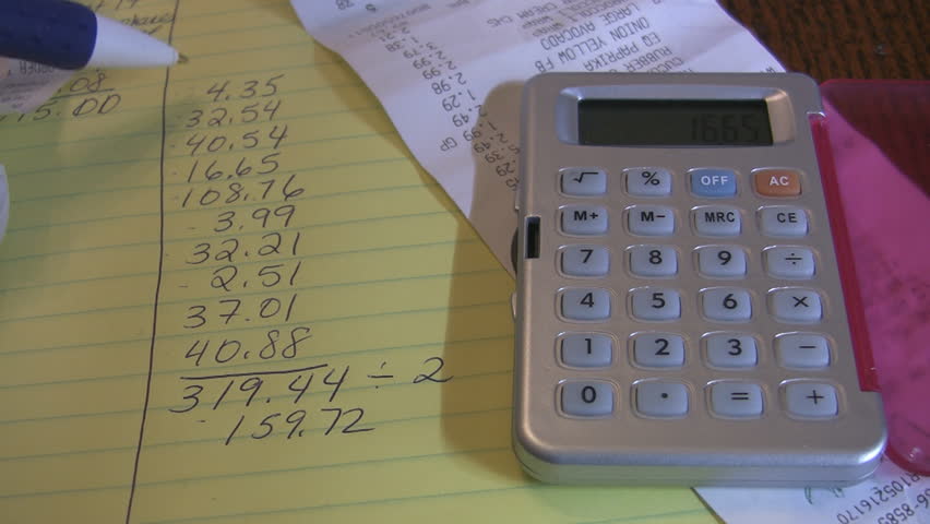 Home finances with calculator and receipt.