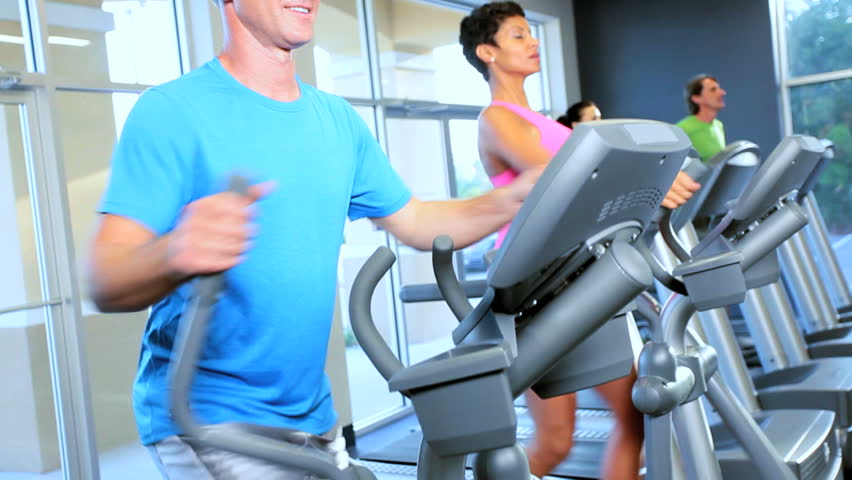 Lower body legs only gym members on exercise equipment