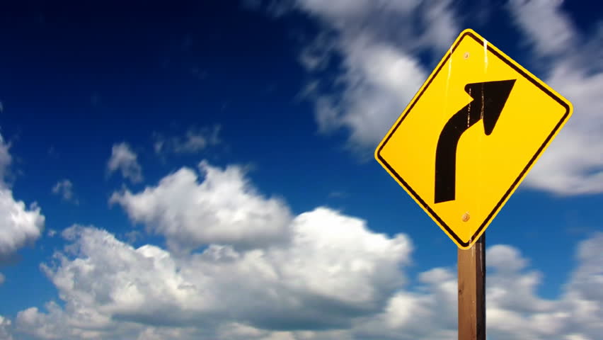 Seamlessly looping clouds with yellow turn sign in front
