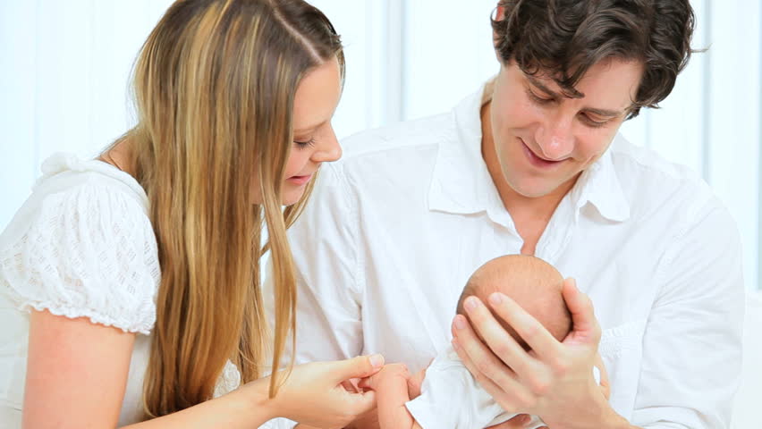 Proud young Caucasian parents with their new baby