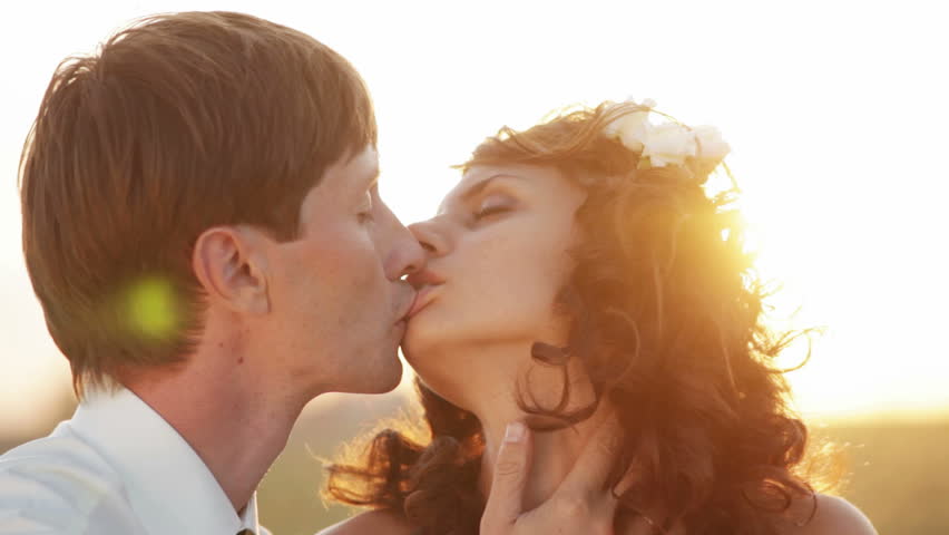 Sensual married couple at sunset. Hot kisses and hugs