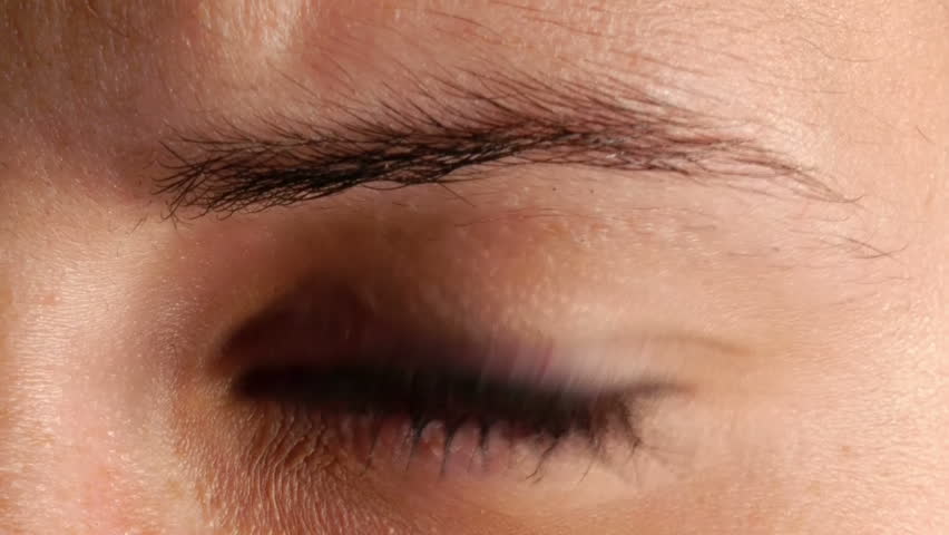 extreme closeup of junkie girls eye with dilated pupil as a result of drug overdose