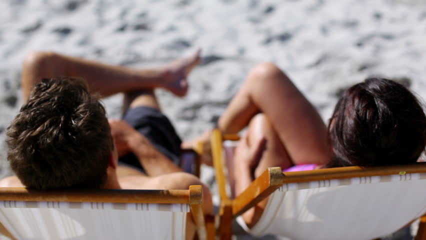 Couple holding hands on the beach