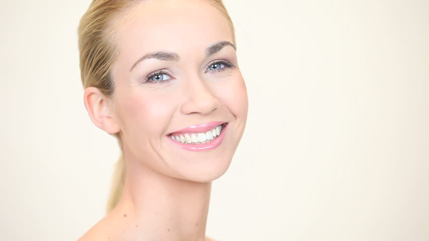 Blonde woman smiling with her head turned