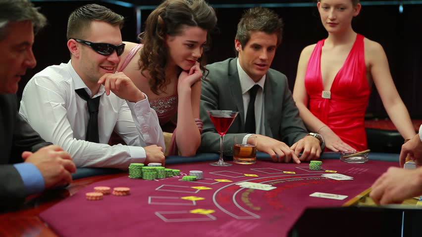 Man in sunglasses winning at blackjack in the casino