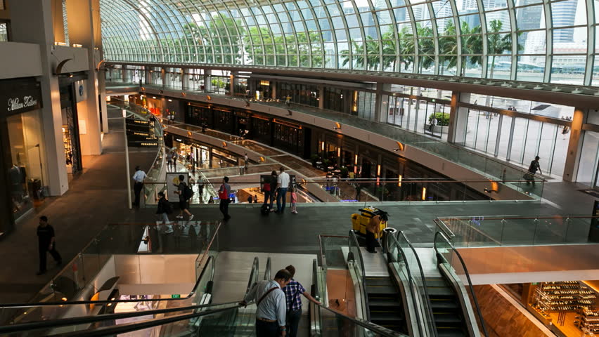 SINGAPORE - 12 OCTOBER 2012: Motion Timelapse of people talking escalators in the Mall of Marina Bay Sands in Singapore