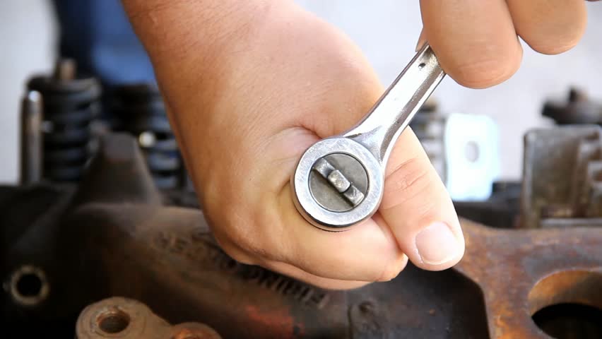 Two Male Hands Holding And Operating A Ratchet Closeup