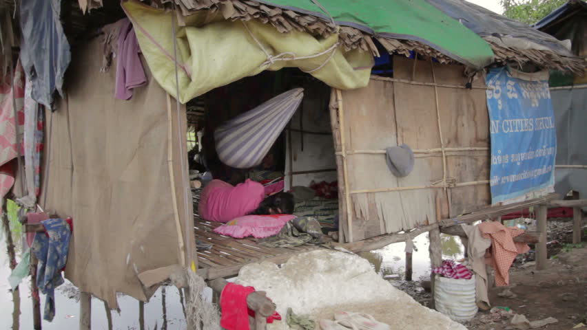 CAMBODIA - CIRCA JUNE 2012: Cambodian family in slum, inside shack
