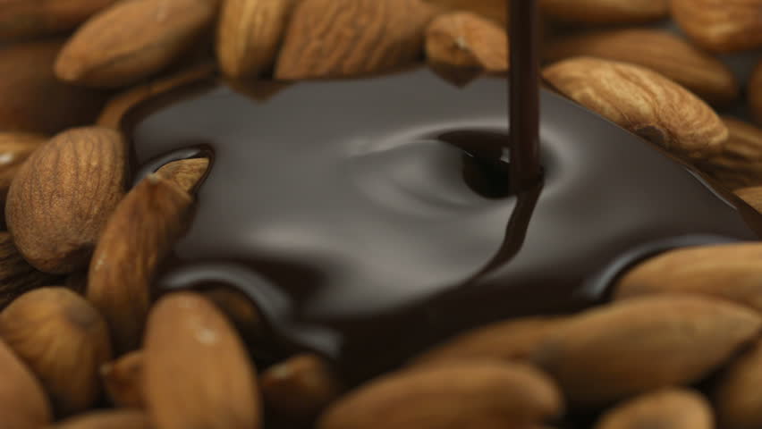 Chocolate sauce on almond shooting with high speed camera.