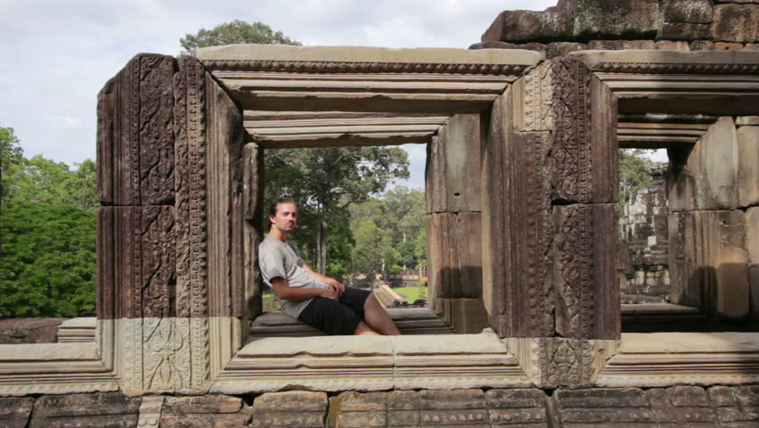 Caucasian tourist travel in baphuon temple looking camera, Angkor, Cambodia