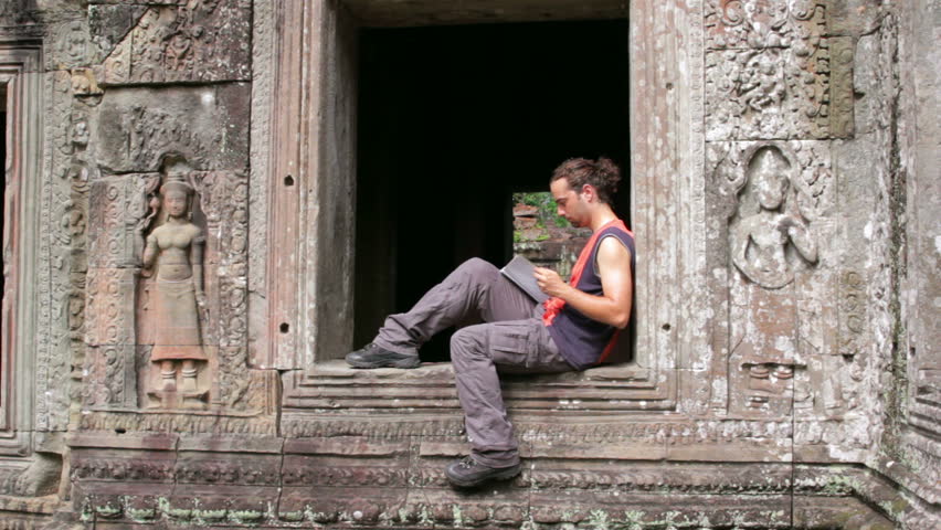 tourist traveling preah khan temple read book, Angkor, Cambodia