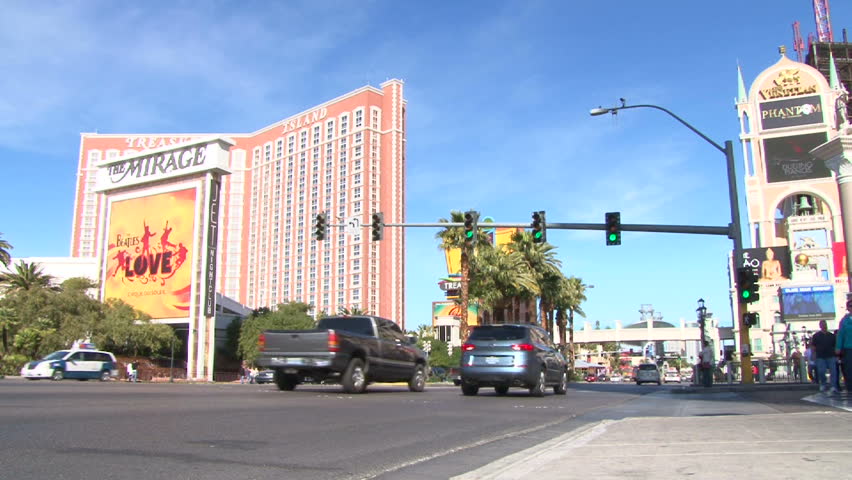LAS VEGAS, NEVADA - CIRCA 2012 - Las Vegas Boulevard Strip with vehicles speeding by on sunny day by the Mirage and Treasure Island resort and casino.