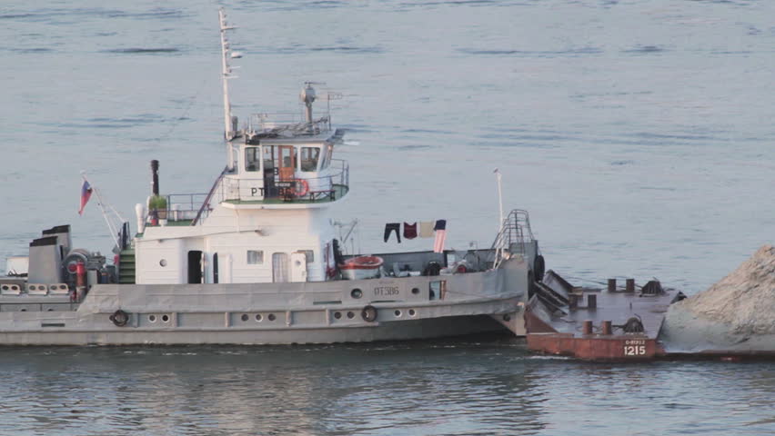 A view of a barge ship transporting sand