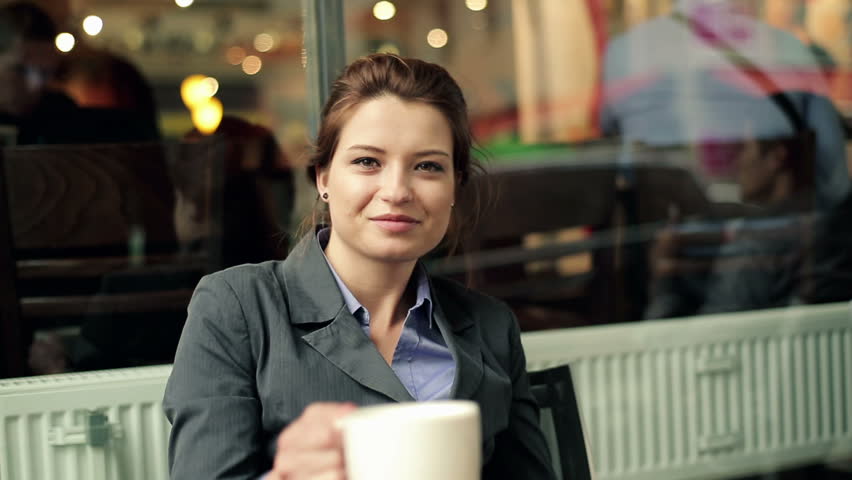 Happy businesswoman gets coffee in cafe, steadicam shot
