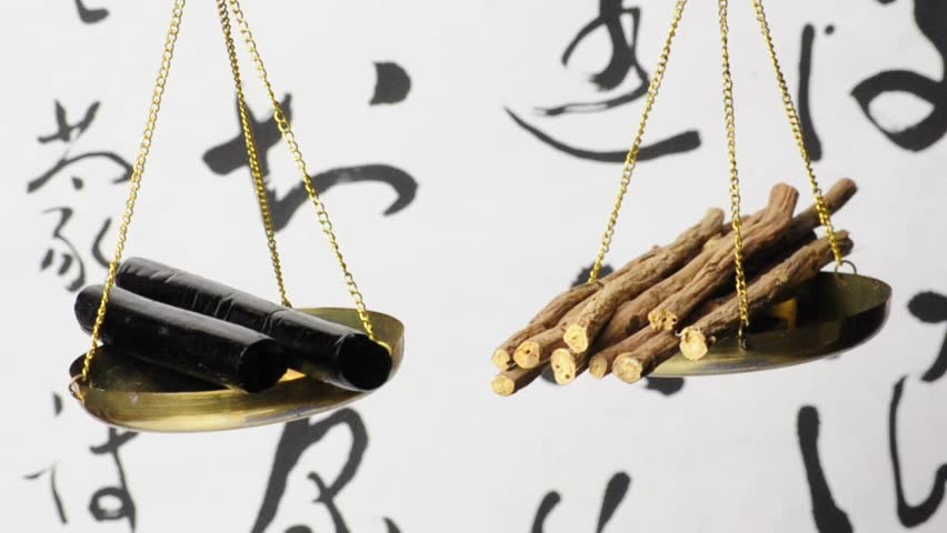 licorice, processed sticks and raw twigs on a balance