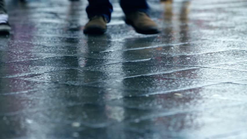 Many People Walking on a Rainy Day with wet shoes in the City with Rain Reflection, in Full HD 1080p