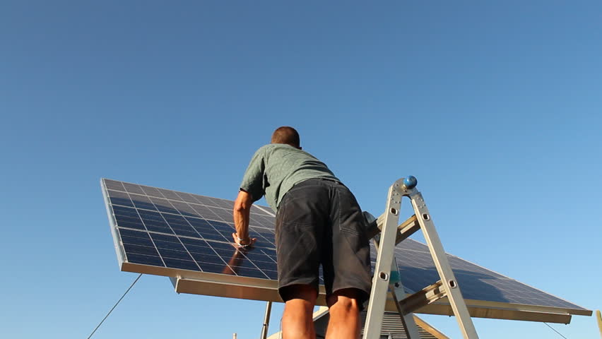 Man maintains, cleans home solar panels. 1080p