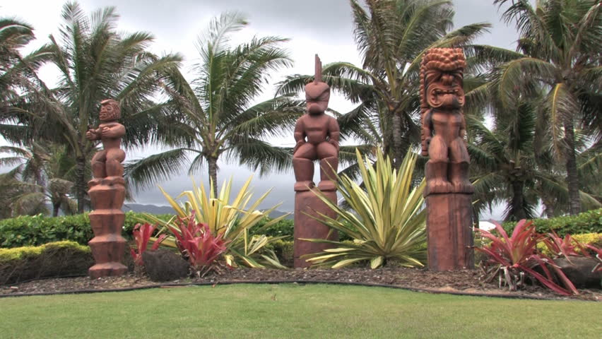 Hawaiian Tiki statues in Oahu, Hawaii. Tropical gardens. Entrance of the Polynesian Cultural Center near BYU Hawaii. Number one tourist attraction in Hawaii.
