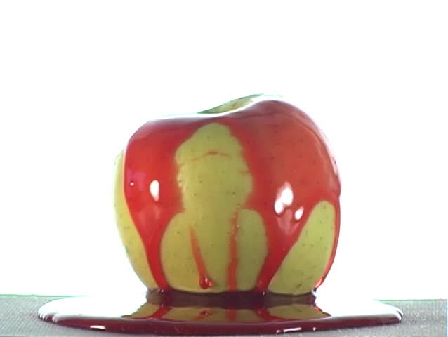 Special-effect:  red syrup lifts off of an apple.  The syrup could be cherry flavor, strawberry flavor, or ???
