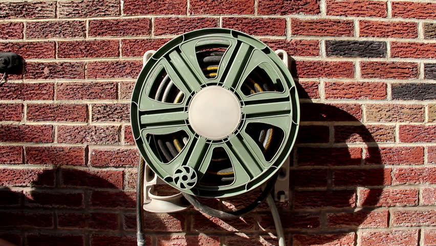 Unwinding a household garden hose.