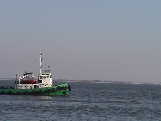 Towboat in  sailing harbor