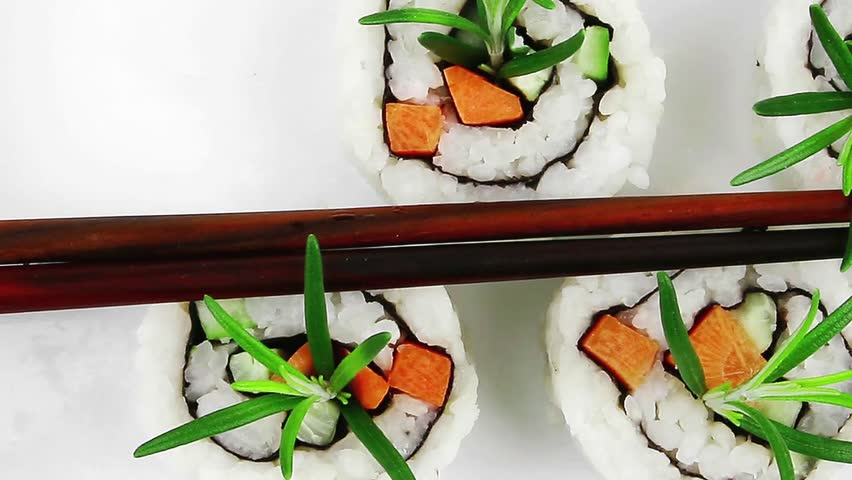 healthy lunch Maki Sushi - California Roll made of Smoked salmon, Cream Cheese and Deep Fried Vegetables inside. With wasabi and ginger. on black table