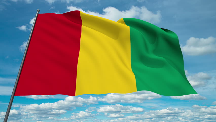 Guinea flag waving against time-lapse clouds background